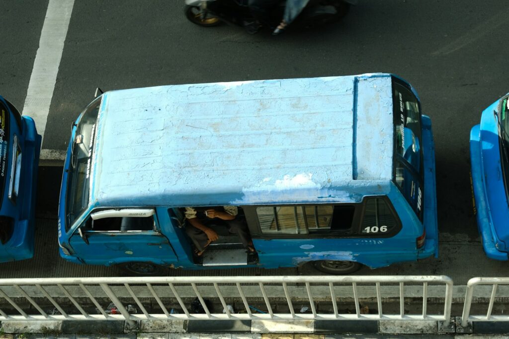 A blue van parked on a street